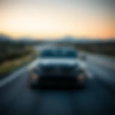 Aerodynamic Curves of a Kia on the Open Road A dynamic shot of a Kia vehicle on an open road showcasing its aerodynamic curves