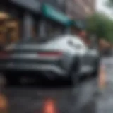 A sleek car parked in a modern urban setting, highlighting its design and features.