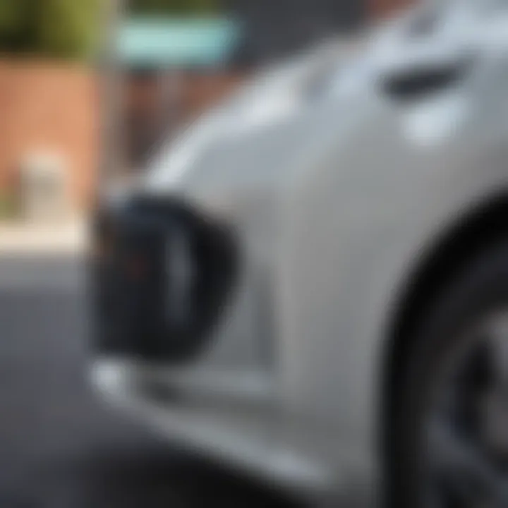 Close-up of the Nissan Leaf's charging port with a charging station in view